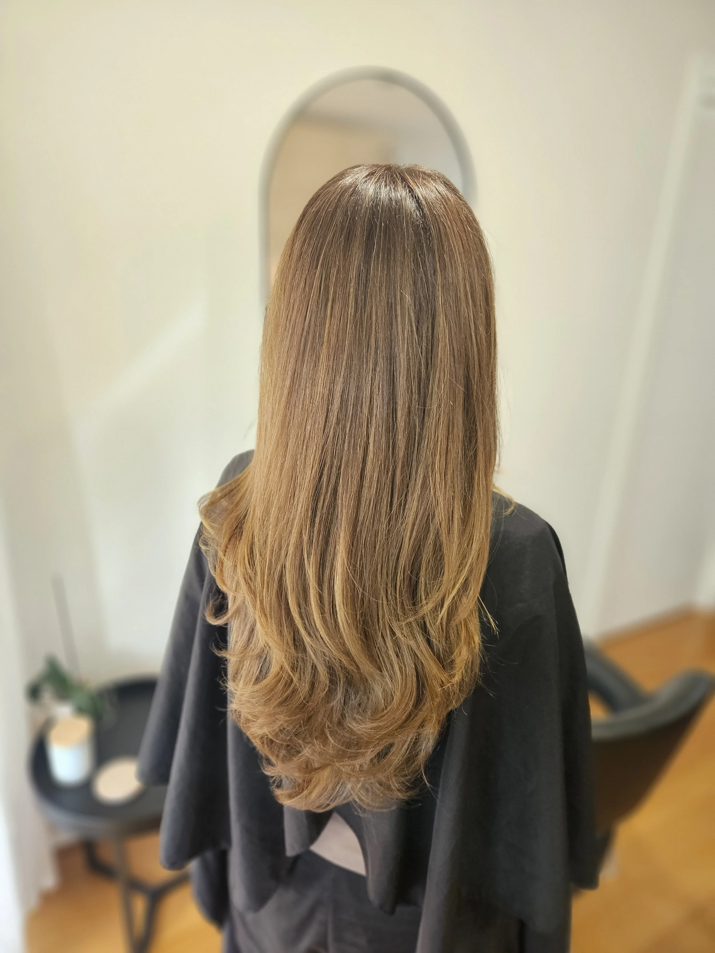 After photo of long layered blonde hair styled at Jazz Up Your Hair in Eagle Vale Sydney.