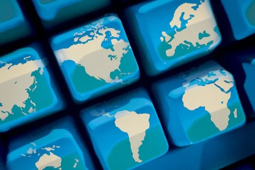 close-up of a keyboard with keys featuring world maps of different continents.