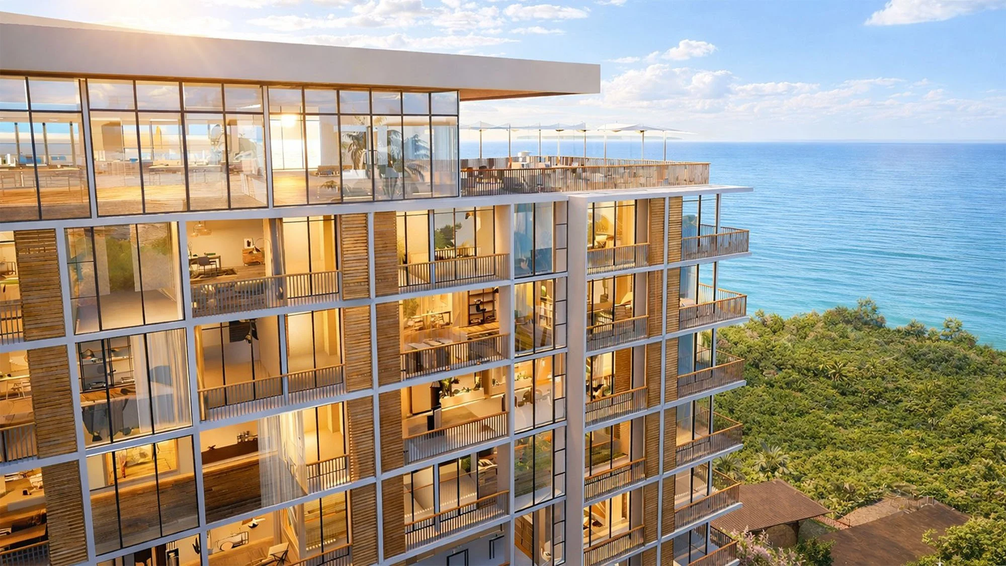 The Palm Haus Roatan - A modern high-rise apartment building with large glass windows and balconies, overlooking the ocean on a sunny day.