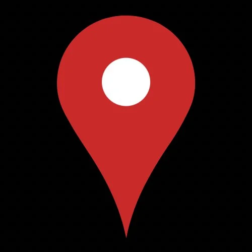 A red map location pin icon with a white circle in the center, on a black background.