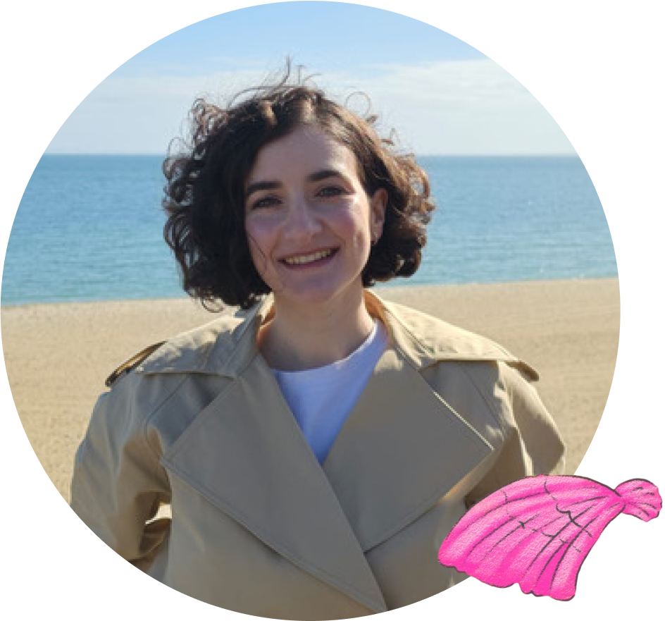 Author Dr Isabelle Schupak standing outdoors near the ocean
