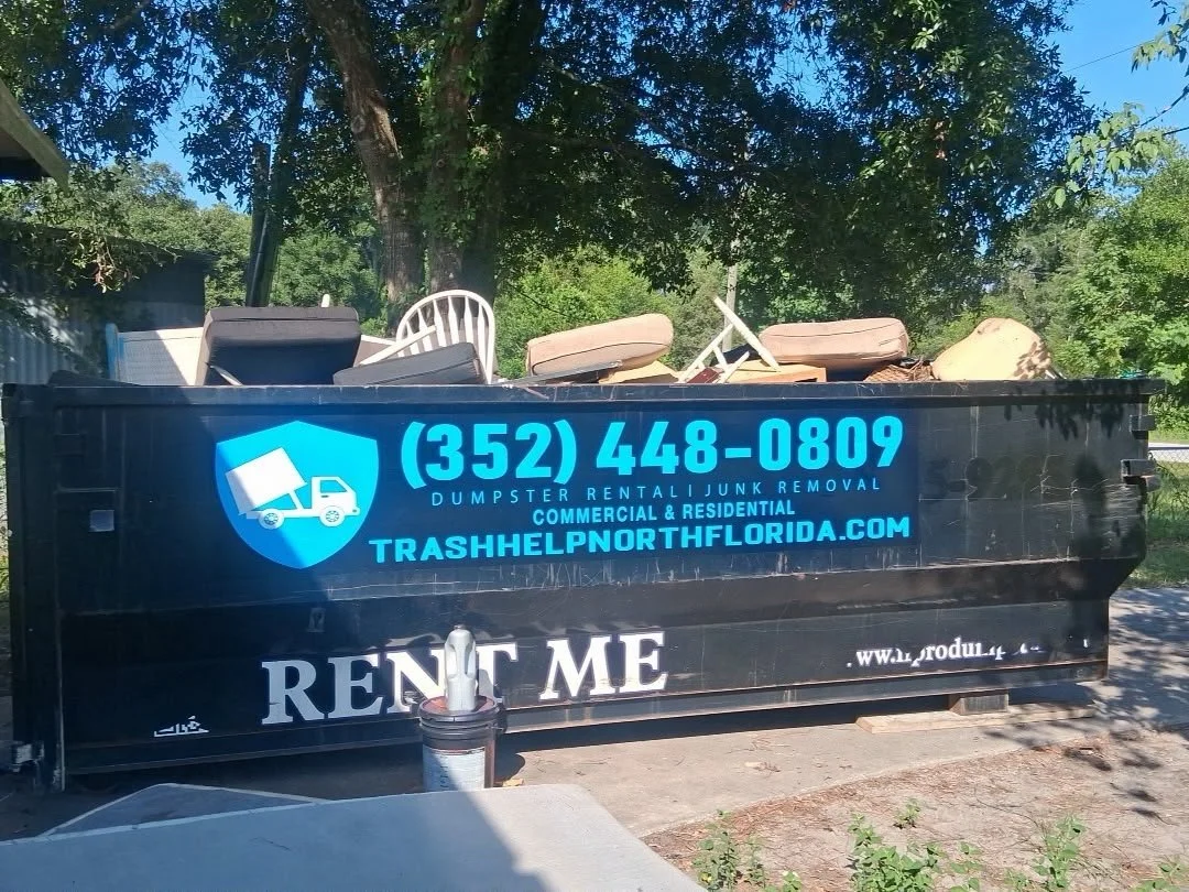 A full dumpster at a mobile home demolition waiting to be picked up.