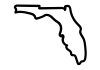 A smartphone with a blank black screen resting on a wooden surface, with a potted plant nearby.