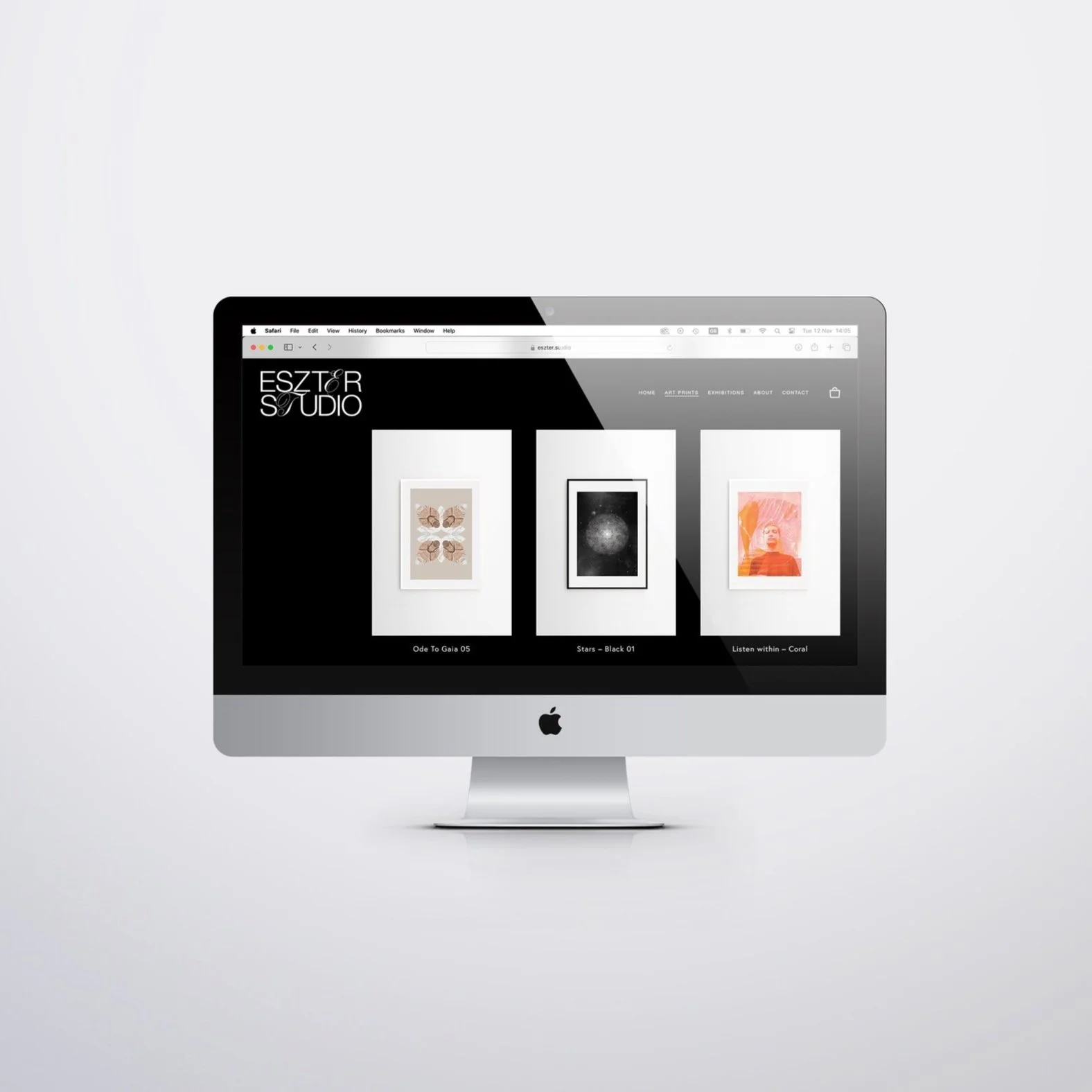 An Apple iMac displaying an online art gallery with three framed artworks on a white wall and navigation menu at the top.