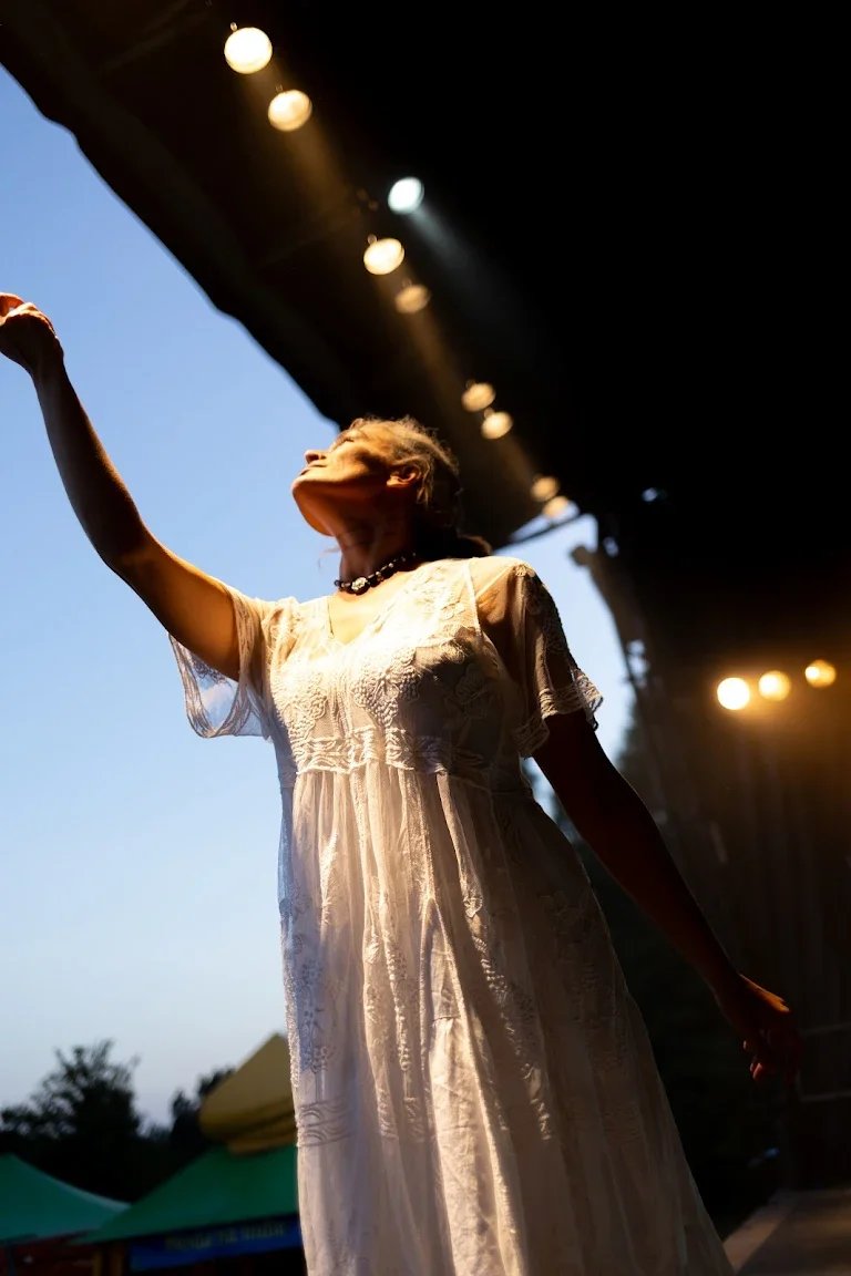Performer in a white dress on stage