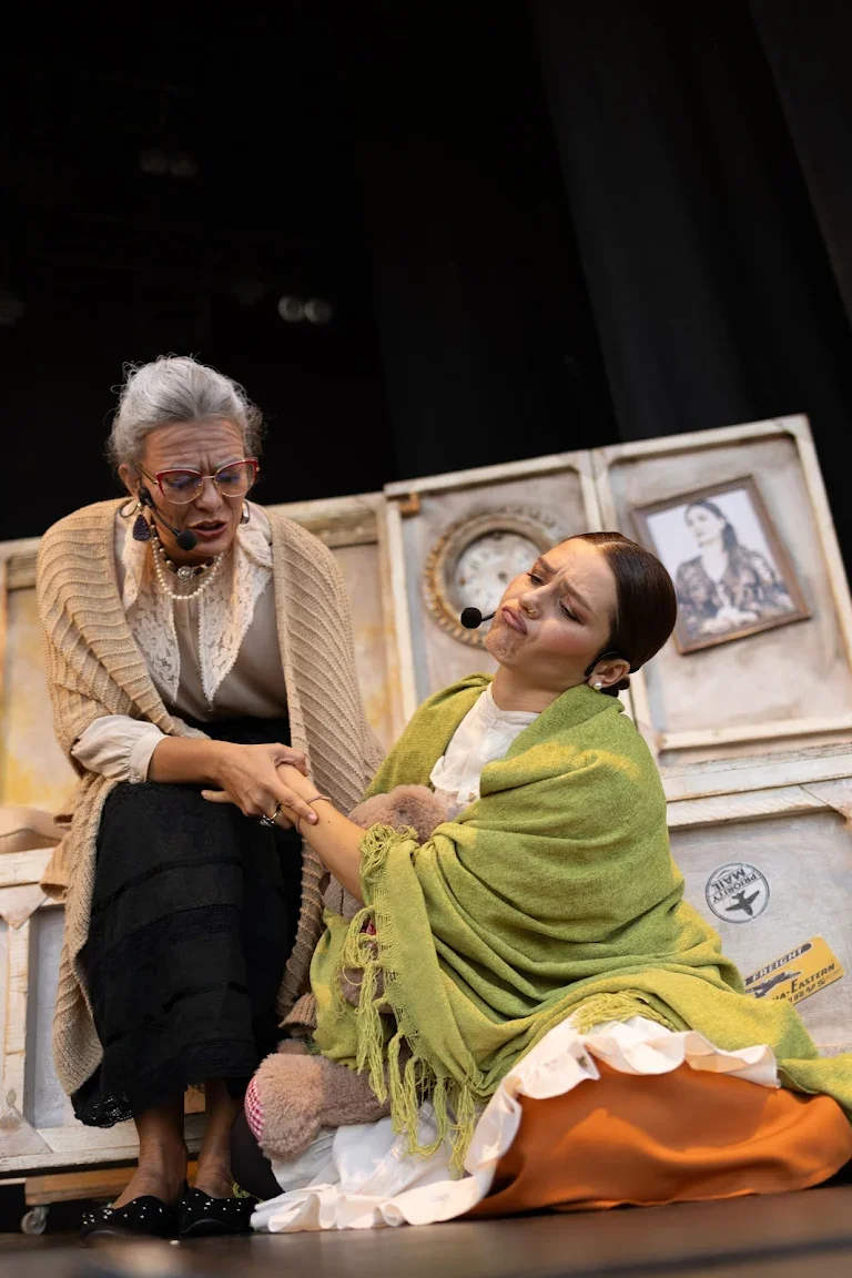 Two performers in a tender scene