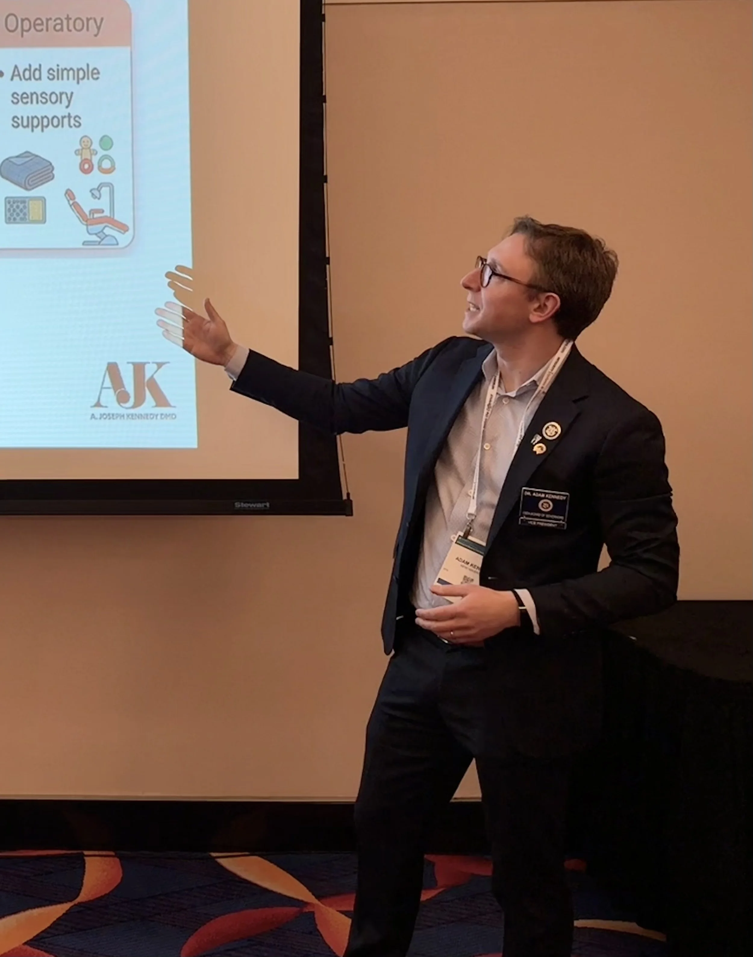Dr. Adam J. Kennedy speaking on dental education and clinical practice