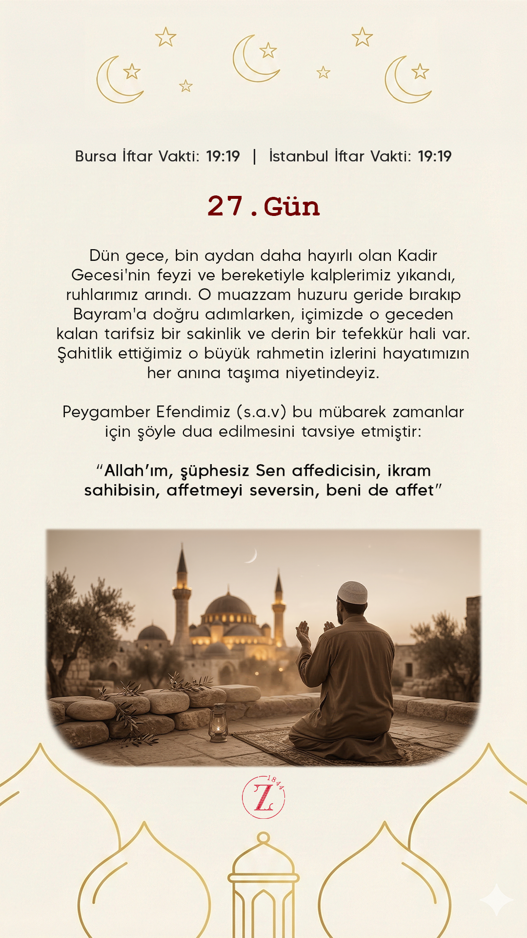 A man praying outdoors at sunset with a mosque in the background, framed by trees and a stone wall.
