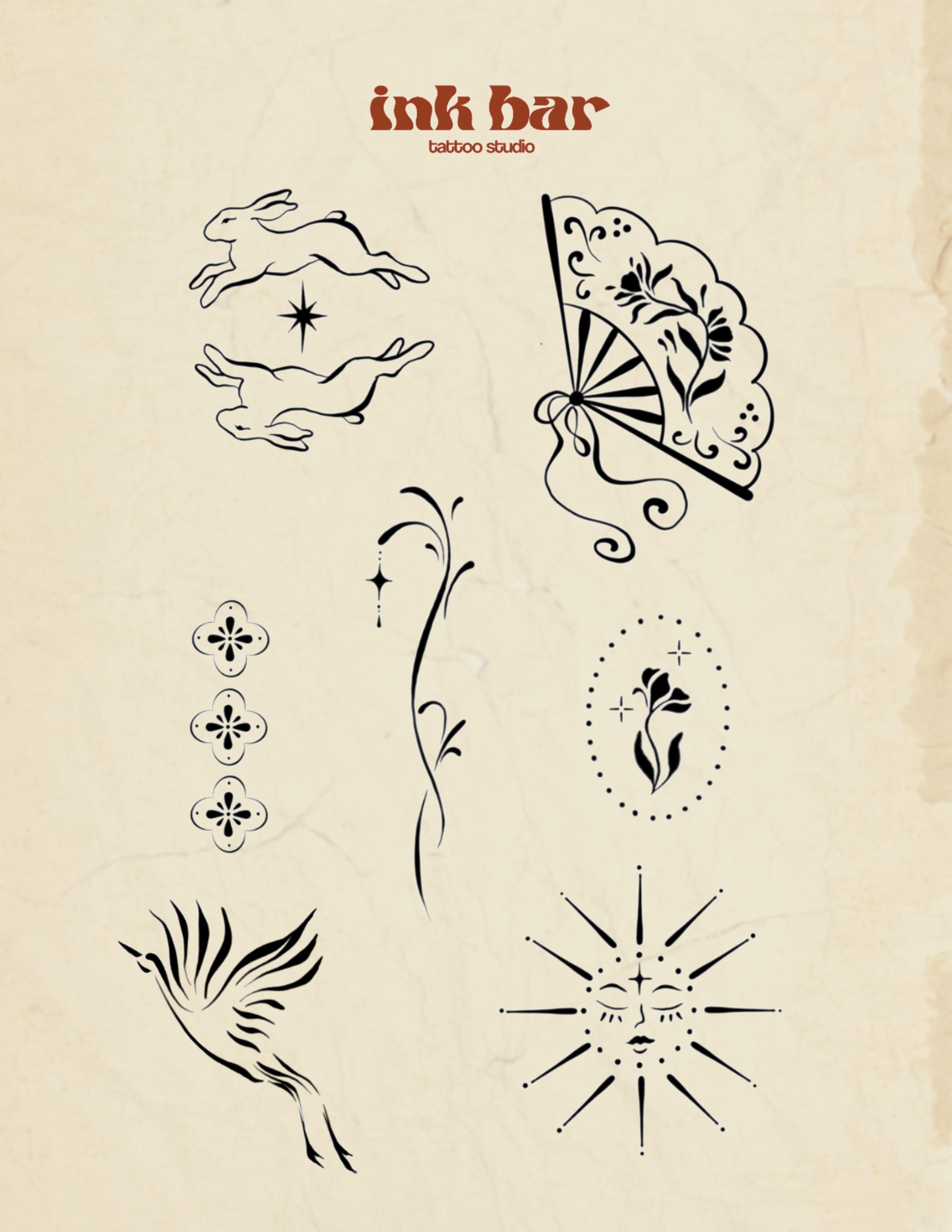 Designs of rabbits, flowers, a fan, and abstract patterns on a beige background, with text reading 'ink bar tattoo studio' at the top.