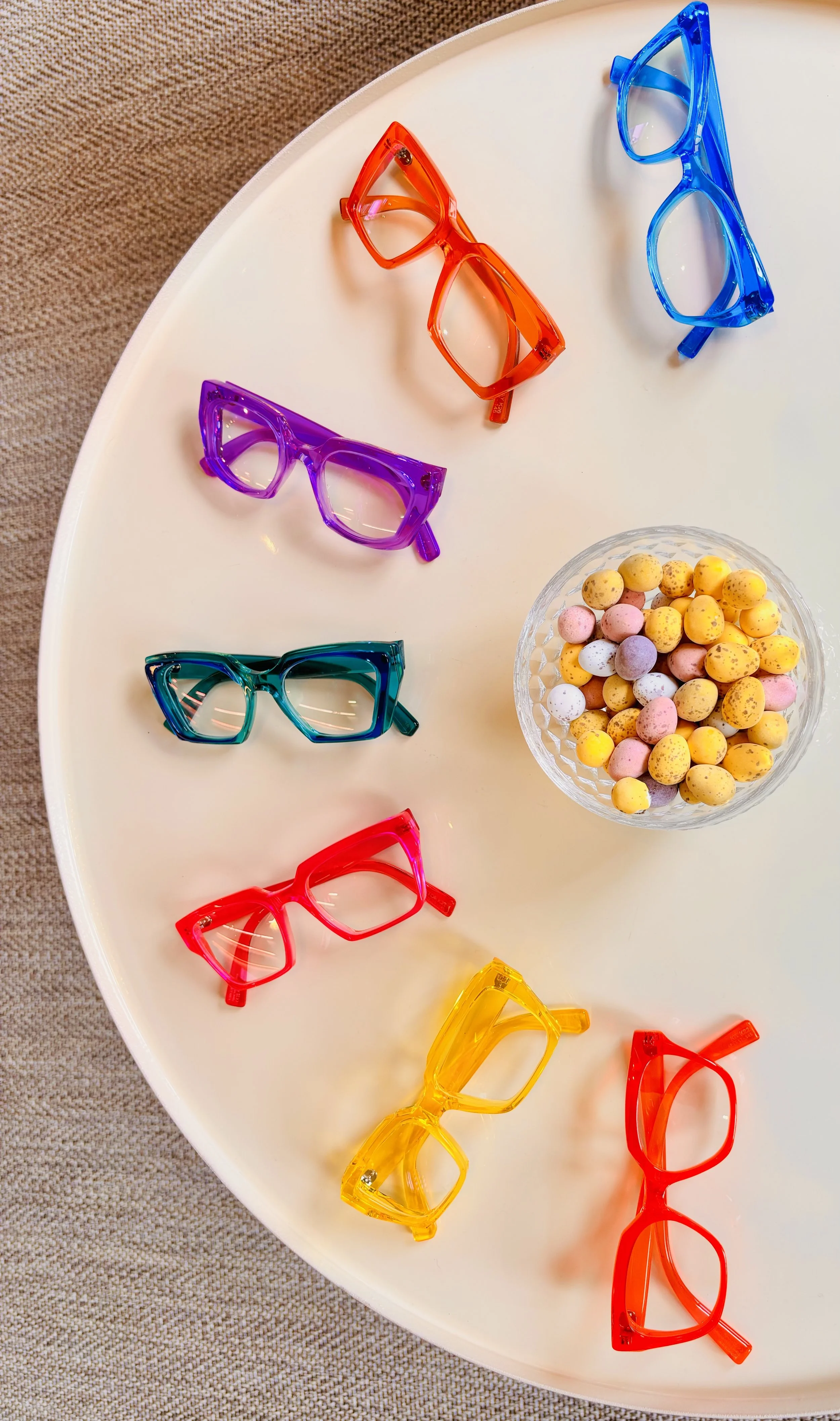 Selection of colourful Kirk and Kirk glasses laid out on a table
