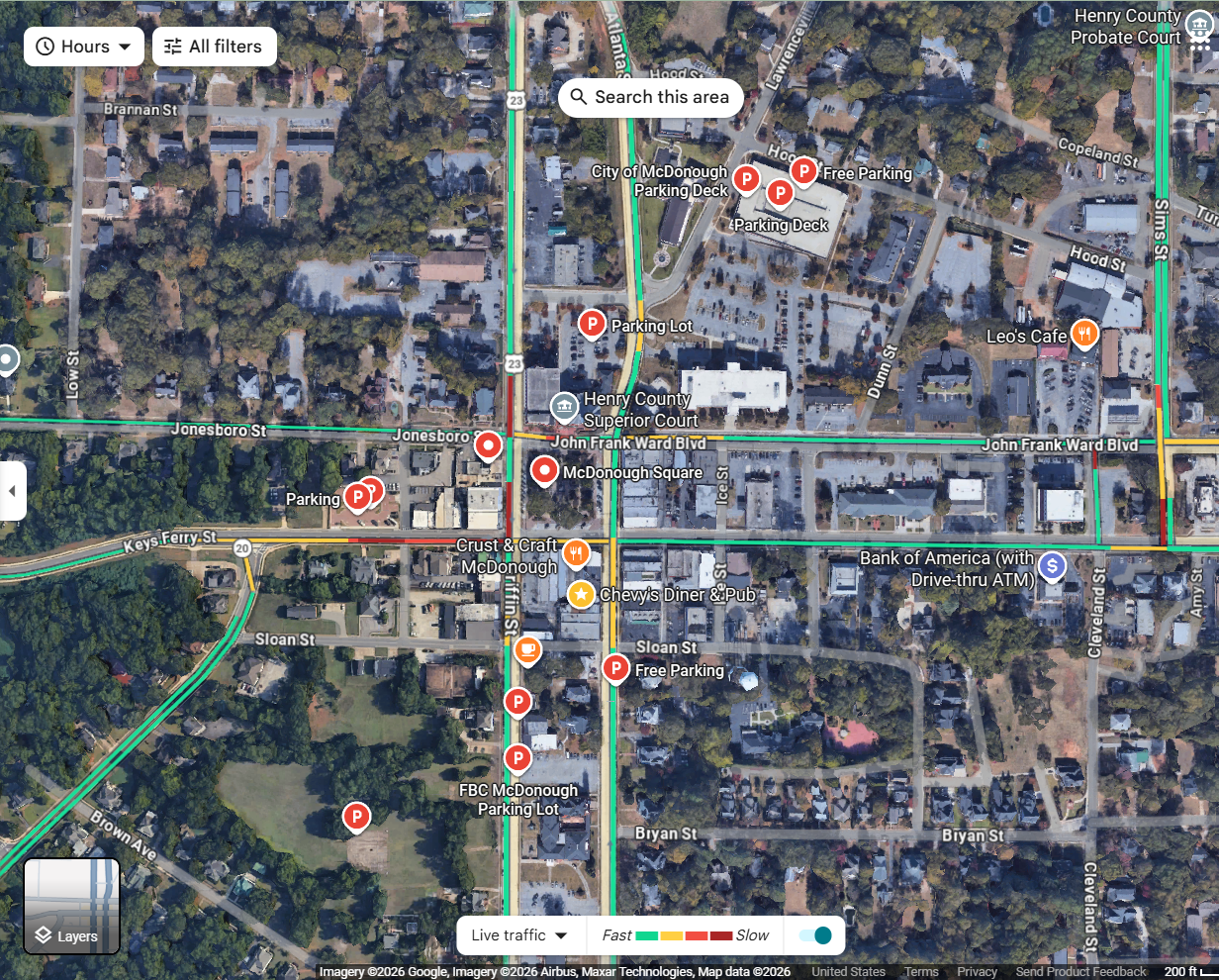 A satellite map view of McDonough, Georgia showing streets, parking lots, and various labeled locations including McDonough Square, Henry County Superior Court, and multiple parking areas. Key streets include Jonesboro Street, John Frank Ward Boulevard, and Sloan Street.