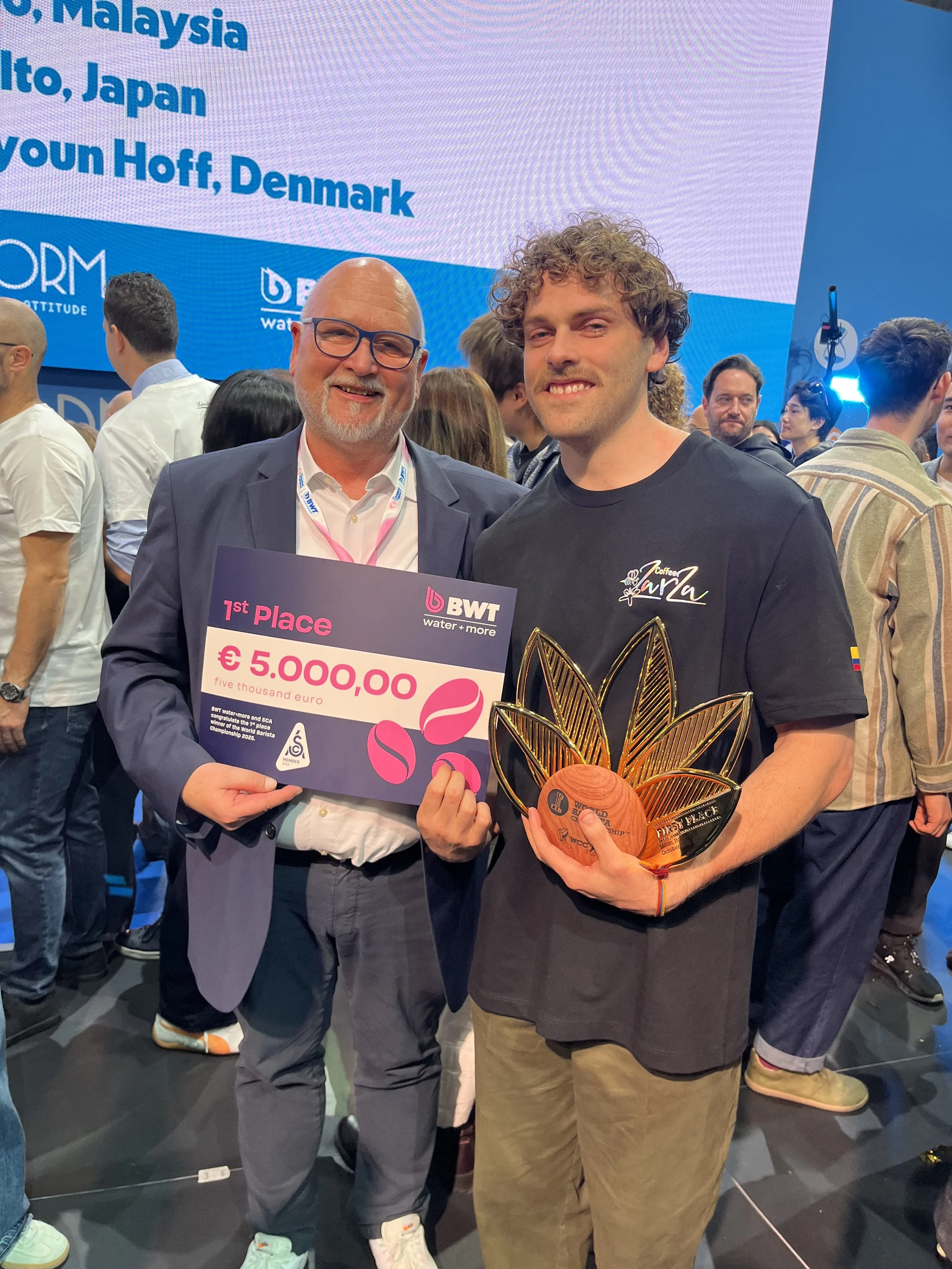  Dr. Frank Neuhausen (left), Managing Director of BWT water+more, congratulates the new World Barista Champion, Jack Simpson, on his victory.   Photo credit: BWT water+more 