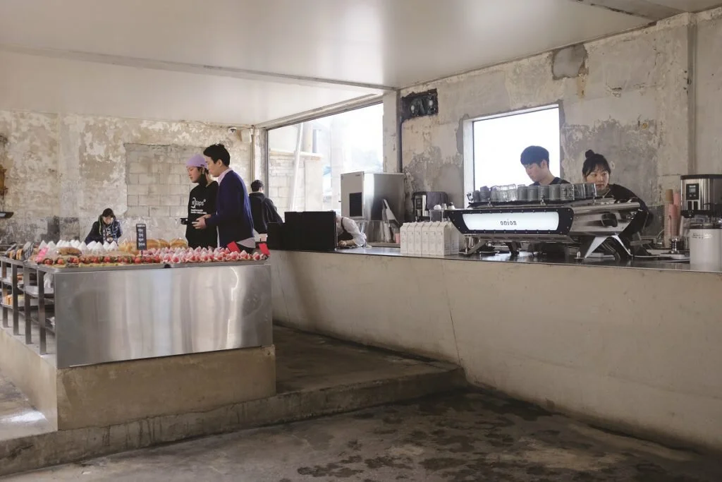 Distressed concrete, minimalist seating, and hard lines are associated with the popular “industrial chic” approach to cafe design as seen at Seoul’s Cafe Onion – but how does the ambient noise impact your sensory perception of your coffee? Photo: Seo Young Yoon.