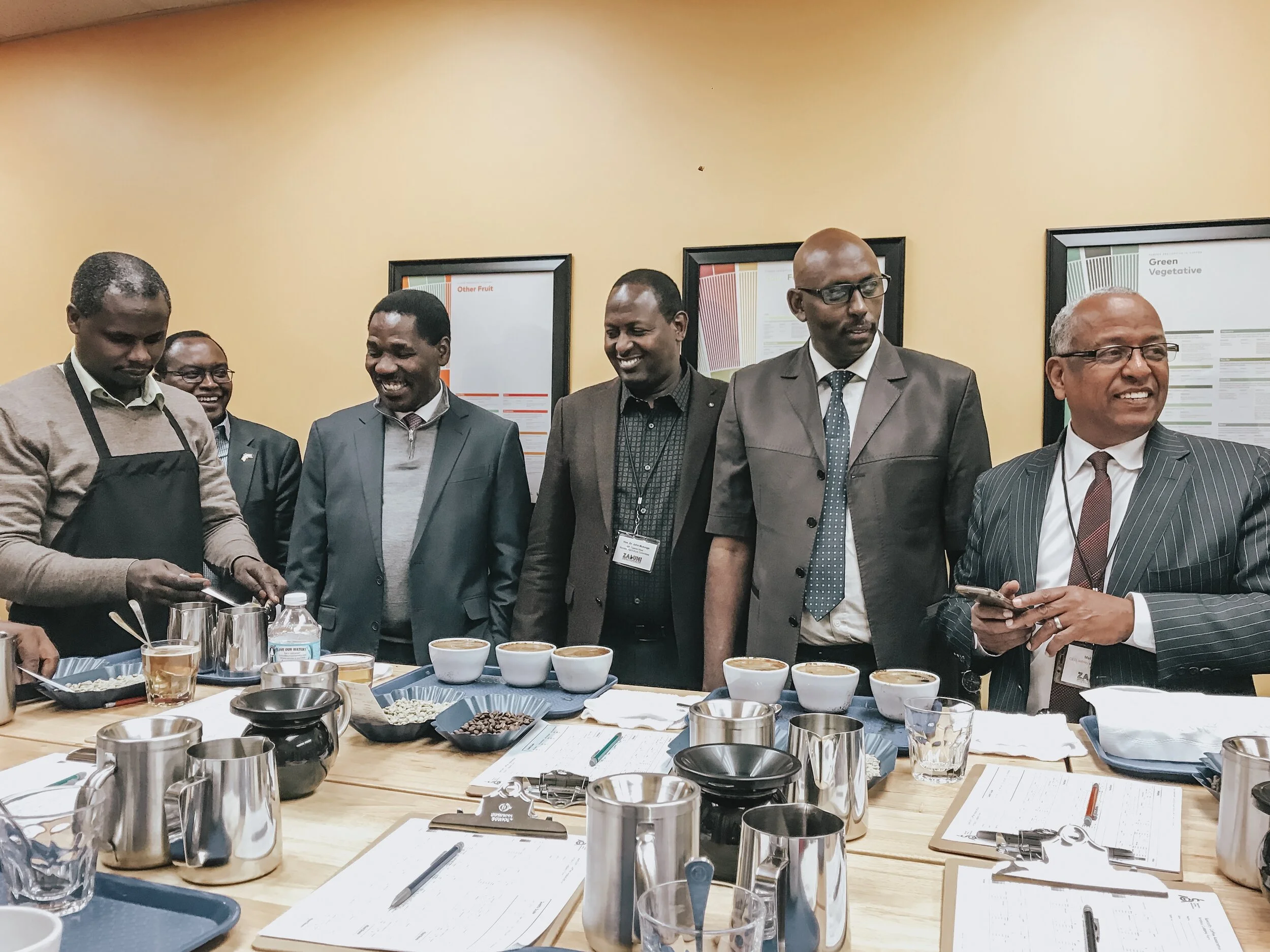 Cupping coffees at Zabuni Specialty Coffee Auction. Left to Right: Anthony Ndung’u, New Kenya Planters Cooperative Union; Ambassador David Gacheru; Hon. Peter Munya, Cabinet Secretary for Agriculture, Livestock, Fisheries, and Cooperatives (Kenya); …