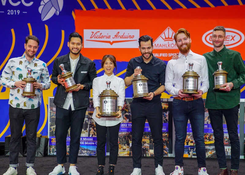 Pictured: Top 6 from the 2019 Wolrd Barista Championship – (1) Jooyeon Jeon – South Korea, (2) Michalis Dimitrakopoulos – Greece, (3) Cole Torode – Canada, (4) Mikael Jasin – Indonesia, (5) Mojtek Bialczak – Germany, and (6) Mathieu Theis – Switzerl…