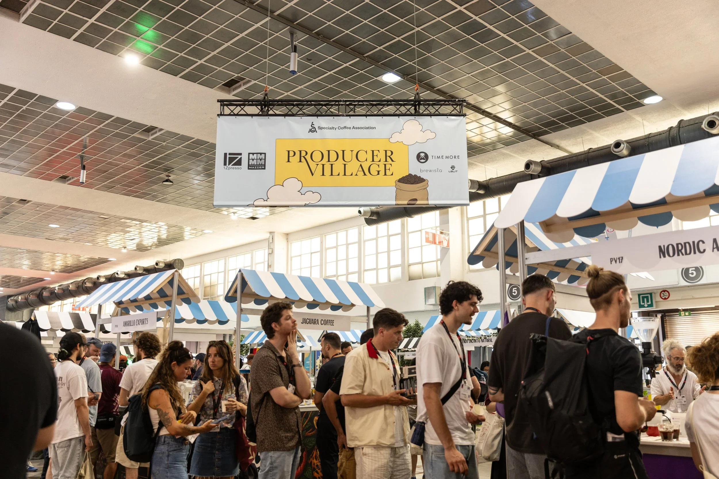 A line forming at the Producers Village feature at a World of Coffee trade show