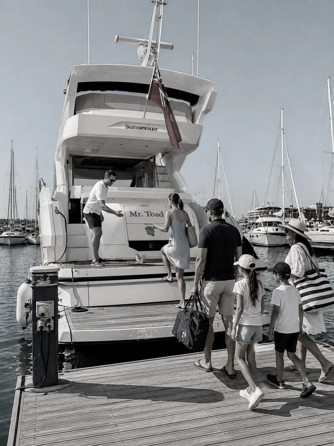Guests boarding luxury charter yacht Mr. Toad at the marina ahead of a private South Coast cruise.