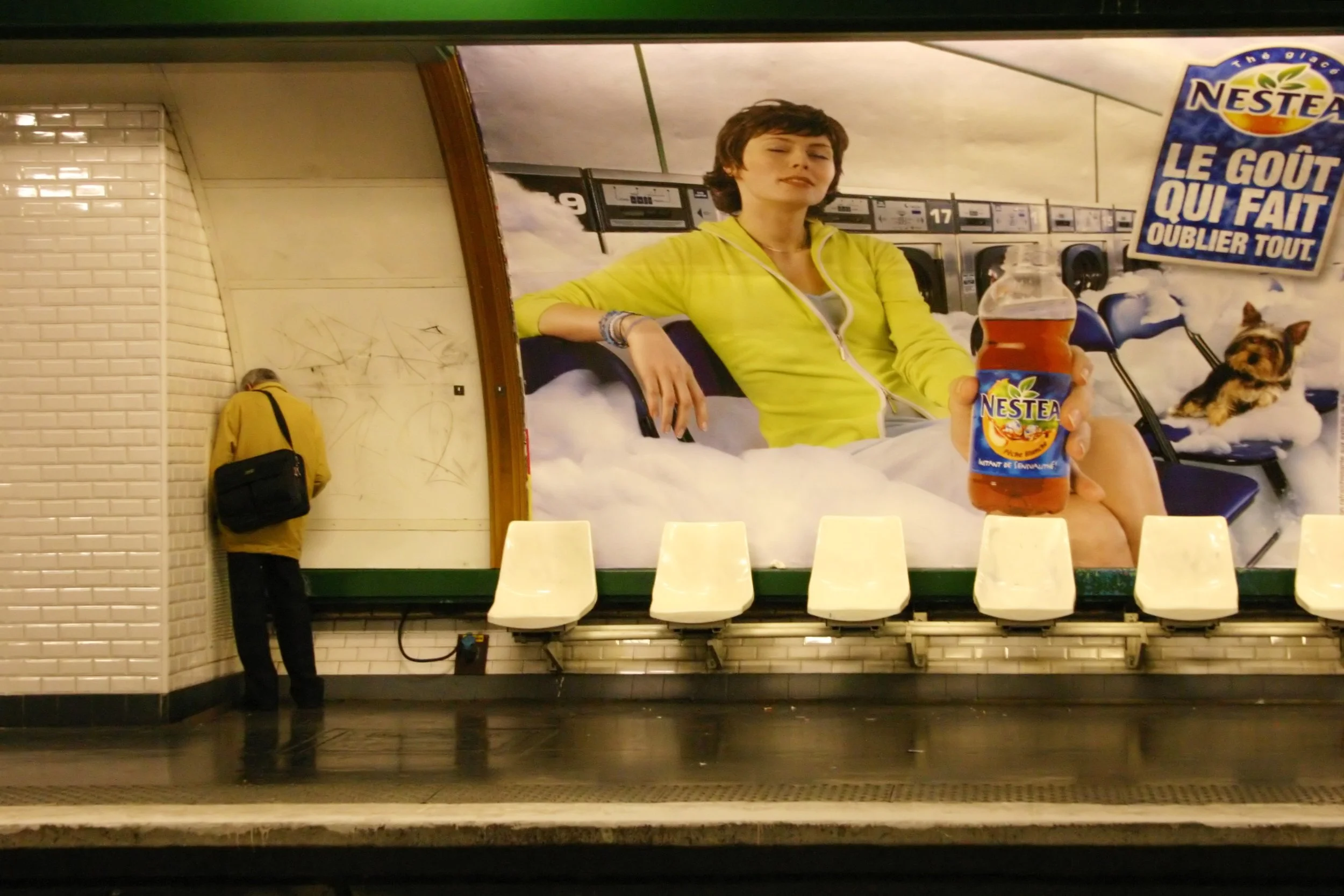 Paris subway. The ad says "The taste that makes you forget everything"
