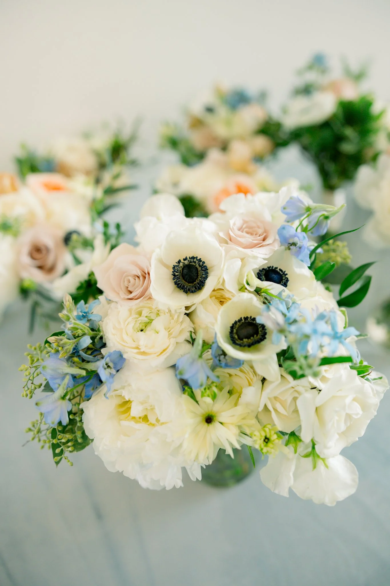 Bouquet of white and cream flowers with hints of blue and green