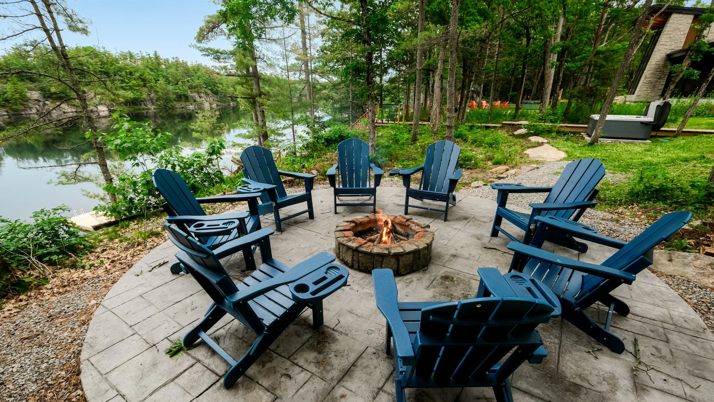 Stone fire pit overlooking a calm Muskoka lake
