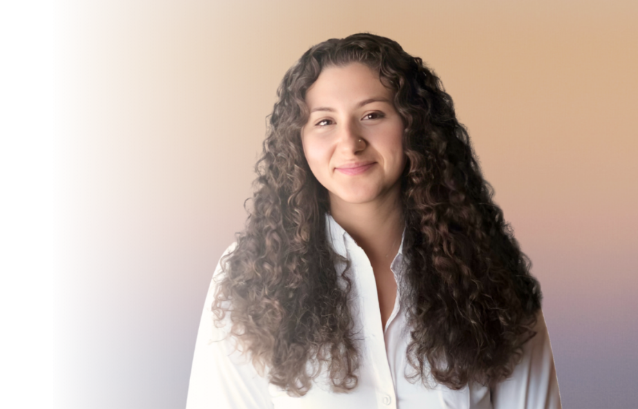 Young woman with long, curly hair smiling softly, wearing a white shirt, against a gradient beige background.