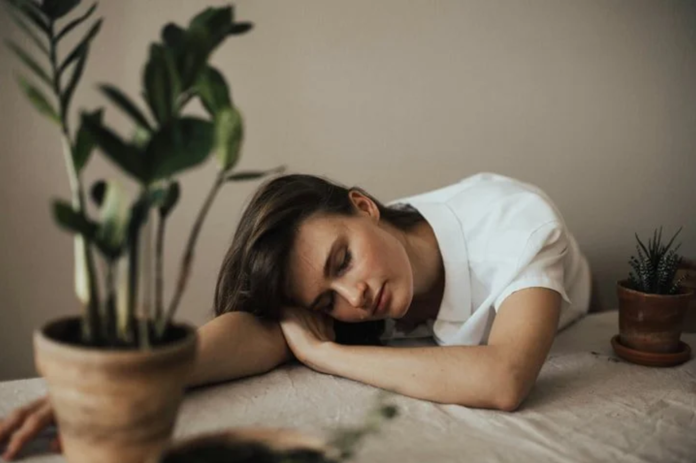 a girl laying down on her table