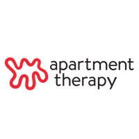Logo of Apartment Therapy featuring a stylized red squiggly abstract red line to the left of black text that reads 'apartment therapy'