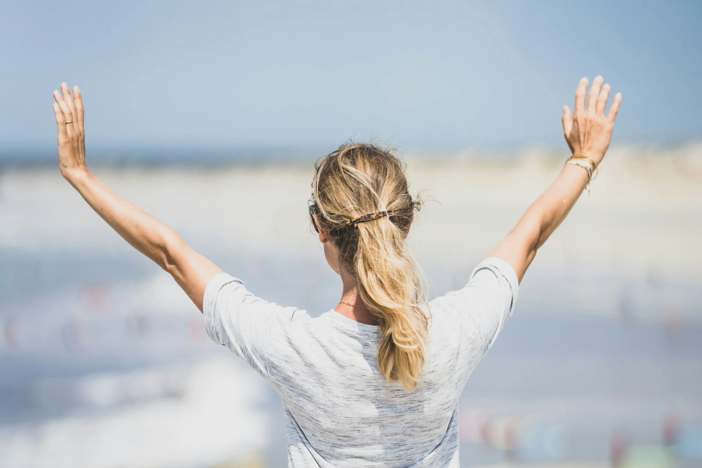 a woman by the ocean stretching