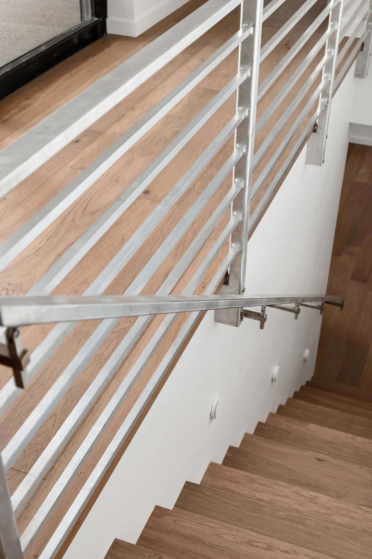 Image showing a wooden staircase with a metal railing from an overhead angle
