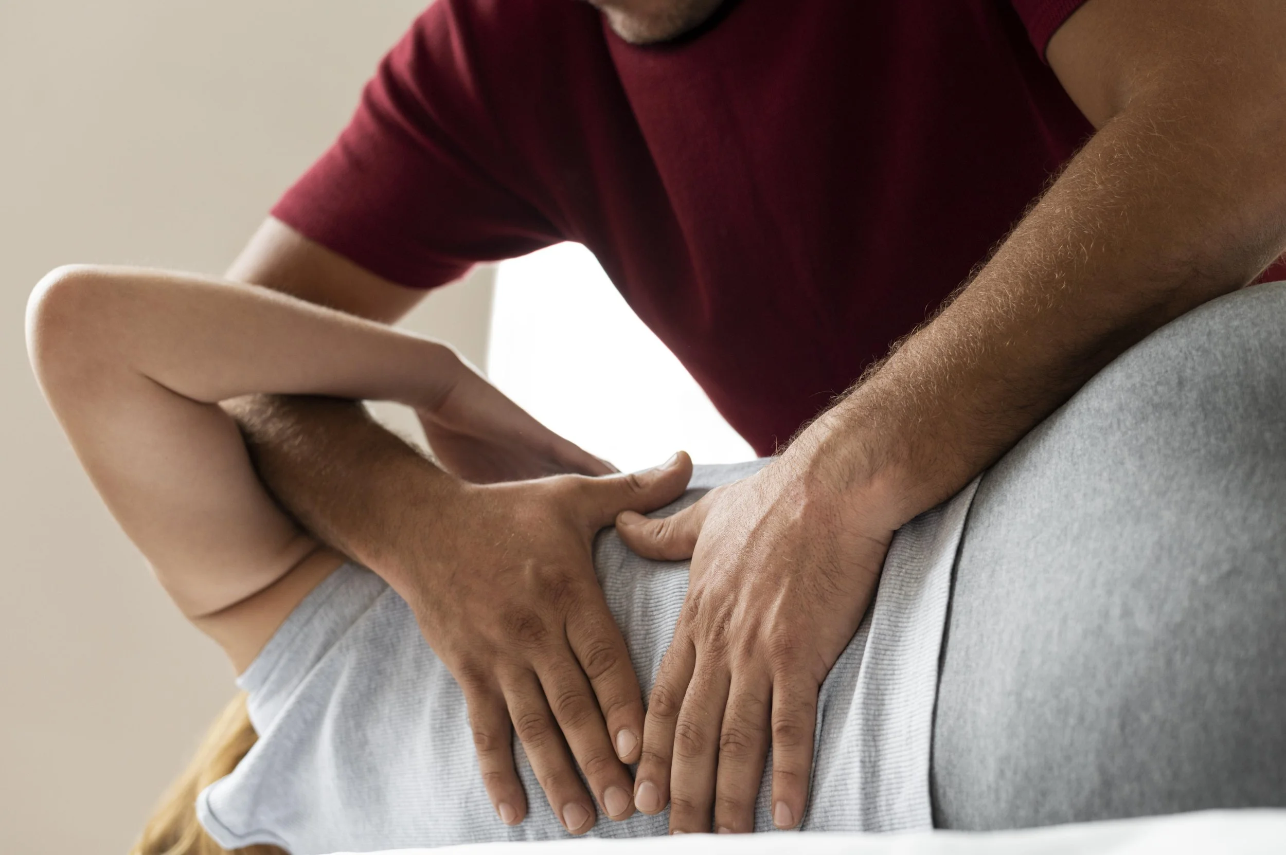 Ostéopathe réalisant une consultation sur le dos d'une patiente