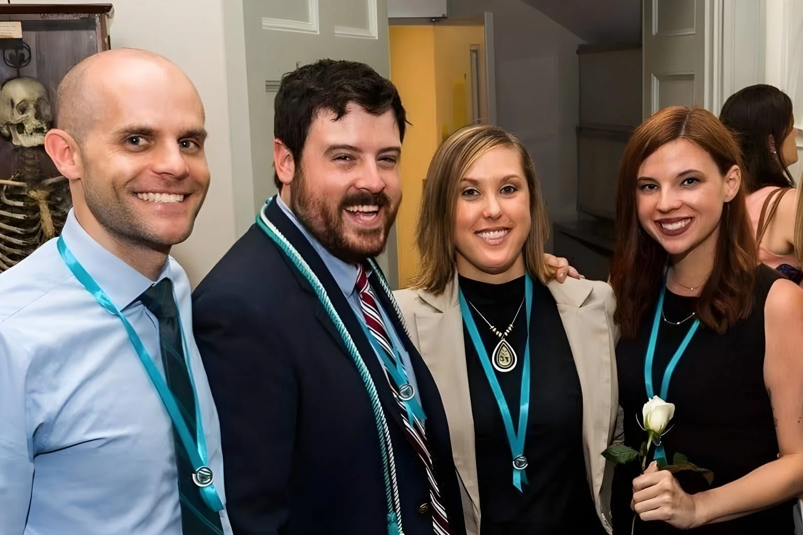 Dan McGuire, Harrison Keyes, Megan Rand, and Sylvia Brandenberg, posing for a photo after graduating from MGH IHP Physician Assistant Studies.