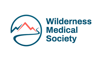 The blue logo of the Wilderness Medical Society. It features a circle with the outline of a mountain inside it.