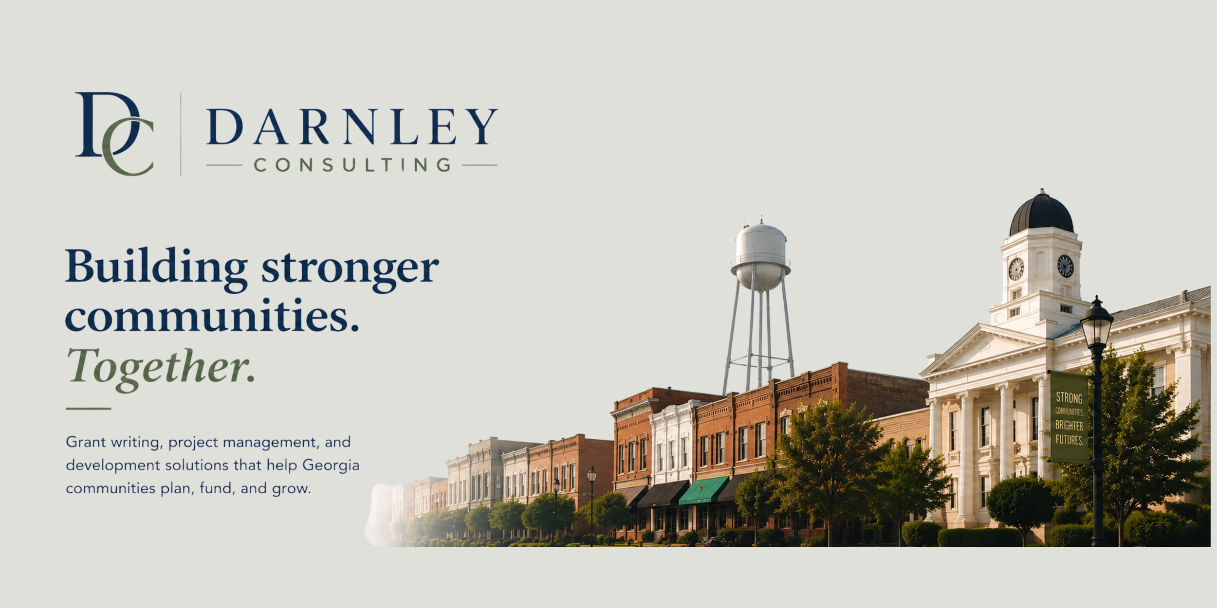 Banner for Darnley Consulting featuring a historic town street with buildings, a water tower, and a clock tower with a dome under a clear sky.