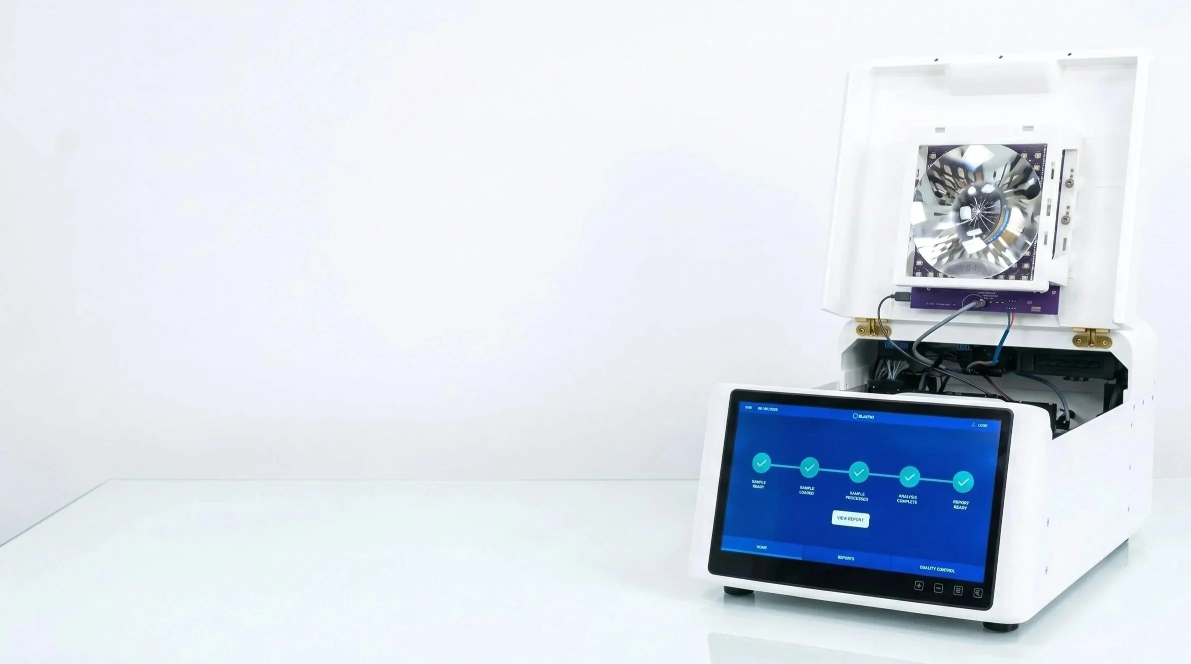 Laboratory equipment with a white enclosure, a computer screen, and a device with a turbine-like component.