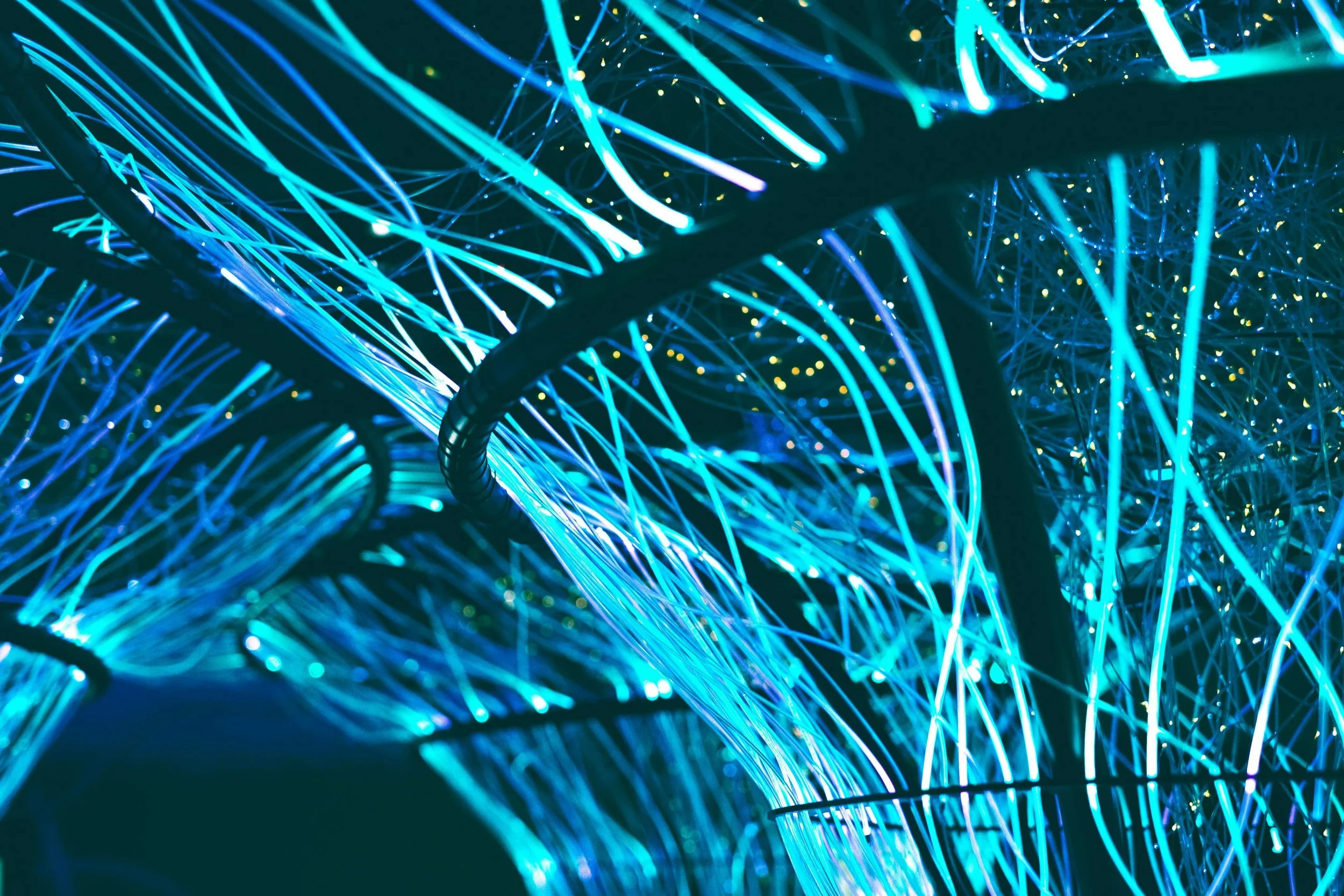 Glowing fiber optic cable strands representing high-performance global network infrastructure by A/Coe Communications.