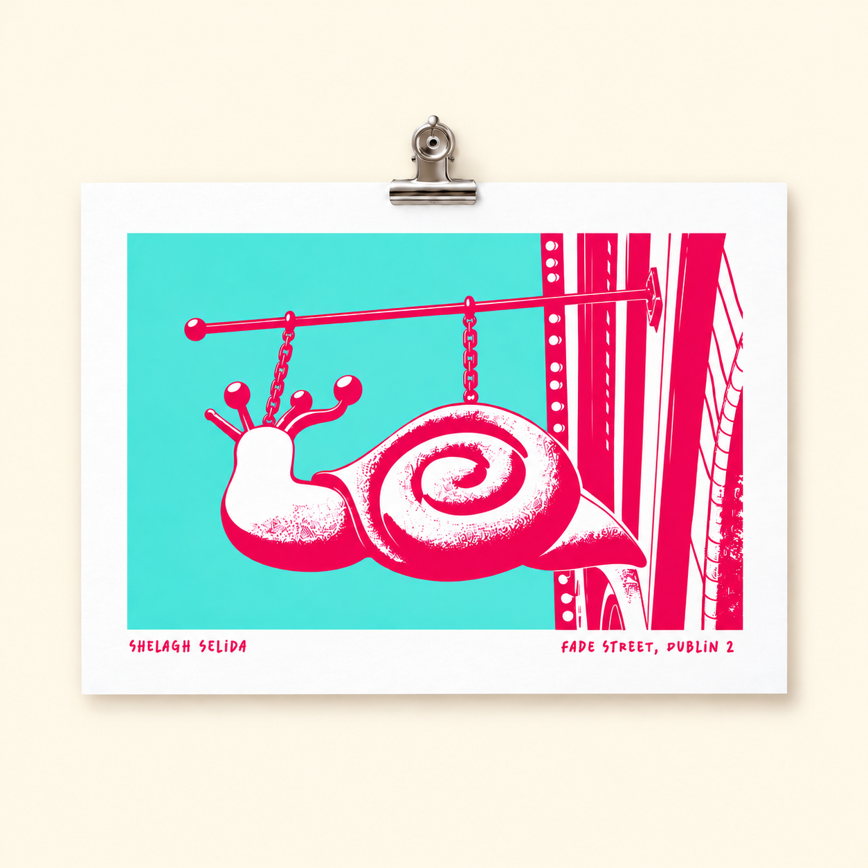 A graphic poster featuring a stylized pink snail with antlers hanging from a horizontal pole by chains, set against a turquoise background with a cityscape silhouette on the right. The poster has text at the bottom reading "Shelagh Selida" and "Fade Street, Dublin 2."