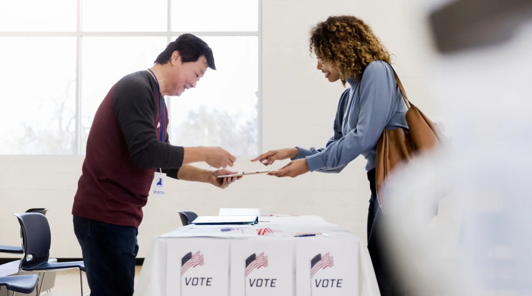 Poll worker helping a voter at a poll station