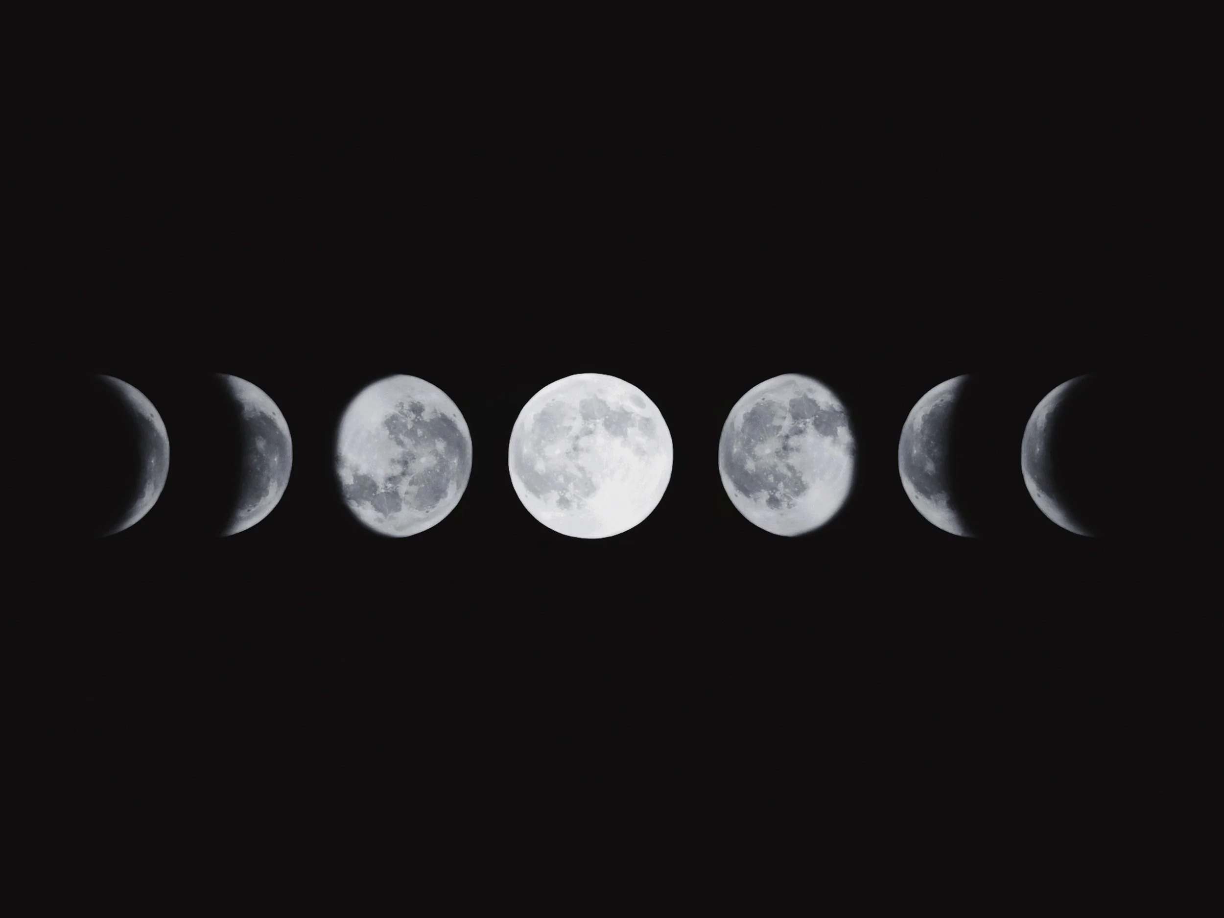 Sequence of images showing different phases of the moon from waxing to waning against a dark night sky.