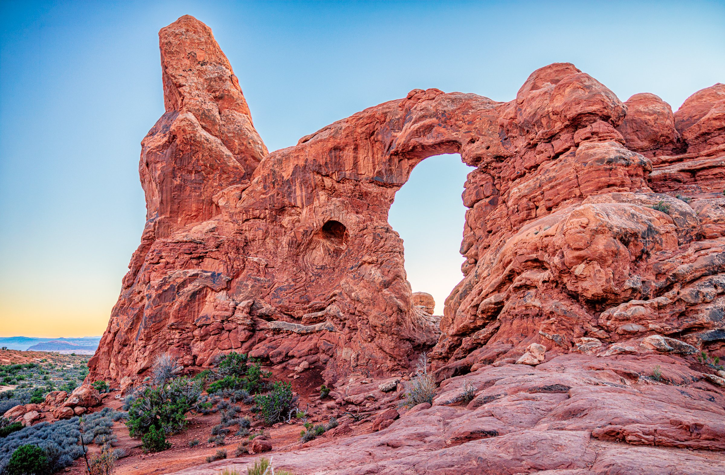 Fine art landscape photography print capturing the massive sandstone structure of Turret Arch glowing in the warm, golden afternoon light of Arches National Park in Utah.