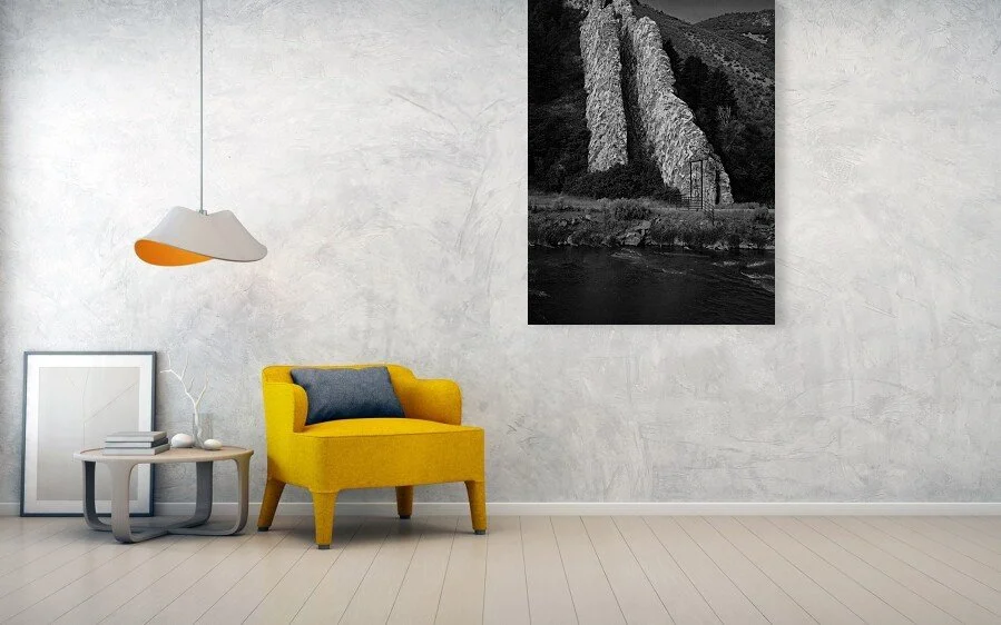 What the Gate Warns fine art print displayed above a yellow chair and small table