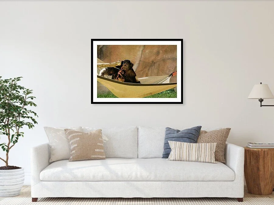 Small Hands fine art print framed above a sofa in a living room