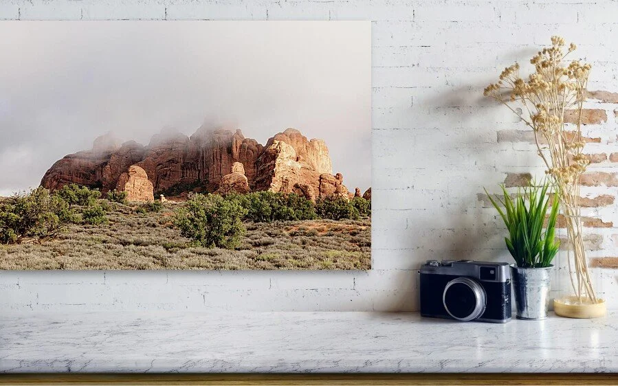 A low hanging cloud over a rock formation in Arches National Park.
