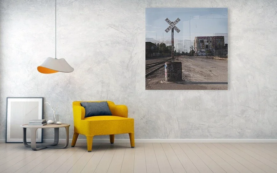 Chair: What the Crossing Remembers fine art print displayed above a yellow chair and small table