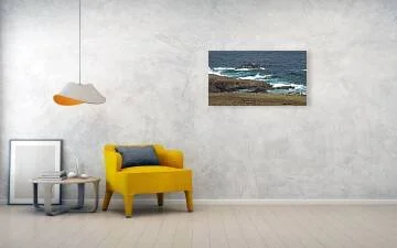 Where the Trade Winds Break fine art print displayed above a yellow chair and small table