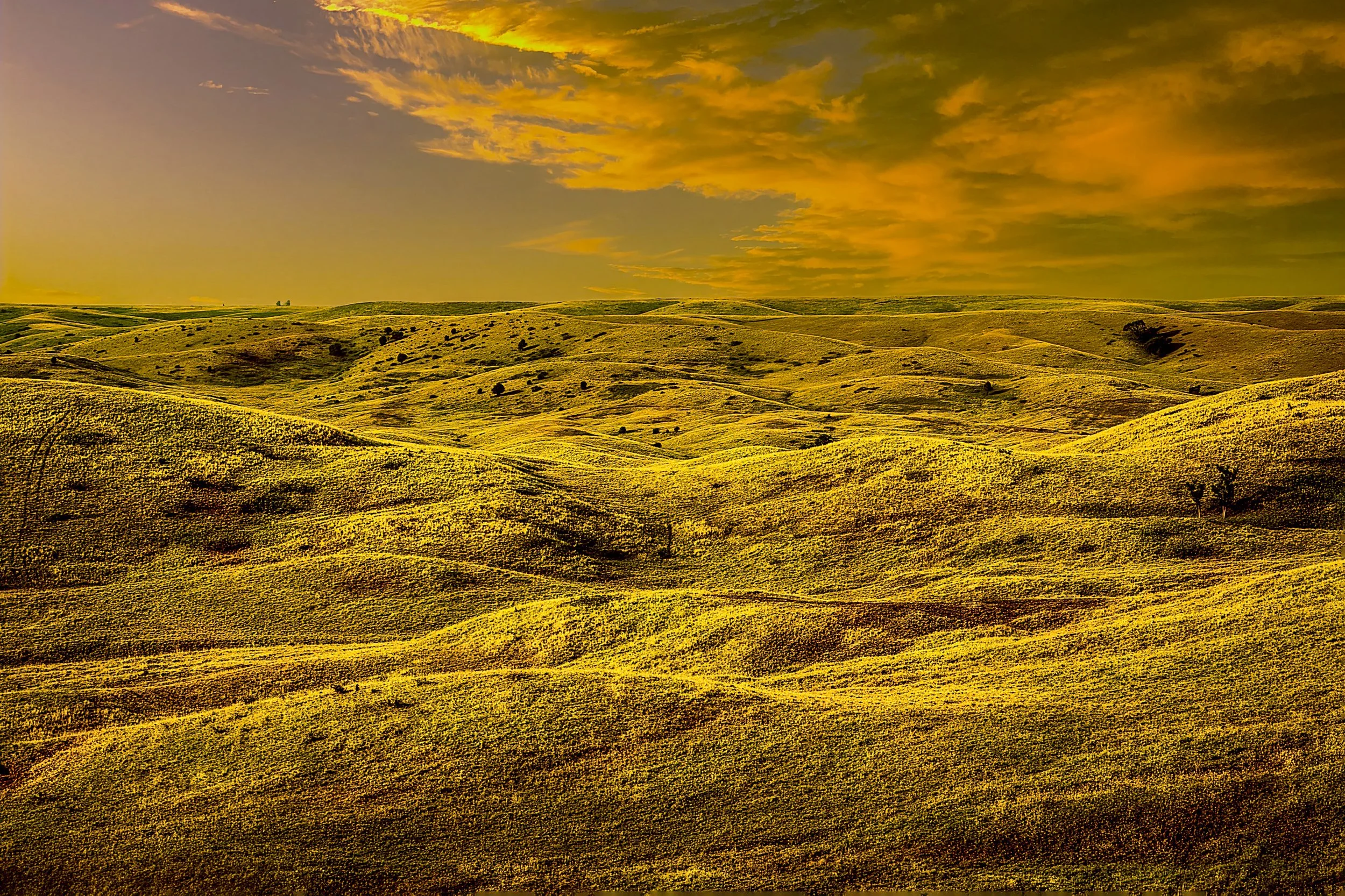 Fine art landscape photography print titled Stillness over Flint Hills, showing undulating Kansas tallgrass prairie under a meditative golden hour sky.