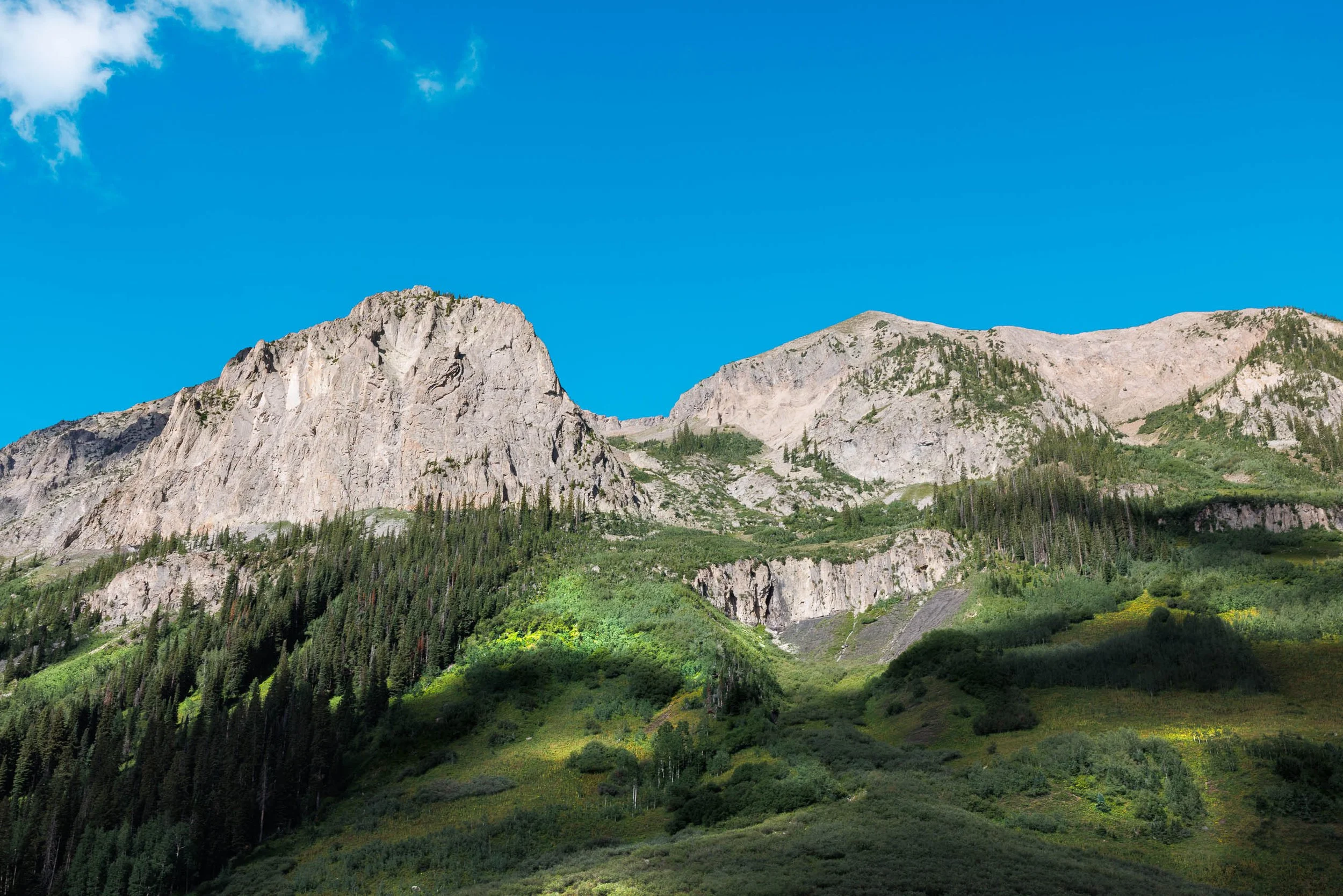 Granite spire and cloud shadow over an alpine meadow above Crested Butte, Colorado — fine art photography print