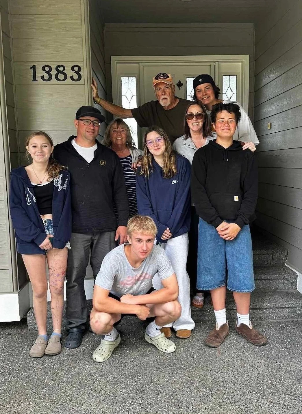 A photo of a family with kids and grandparents smiling for a photo