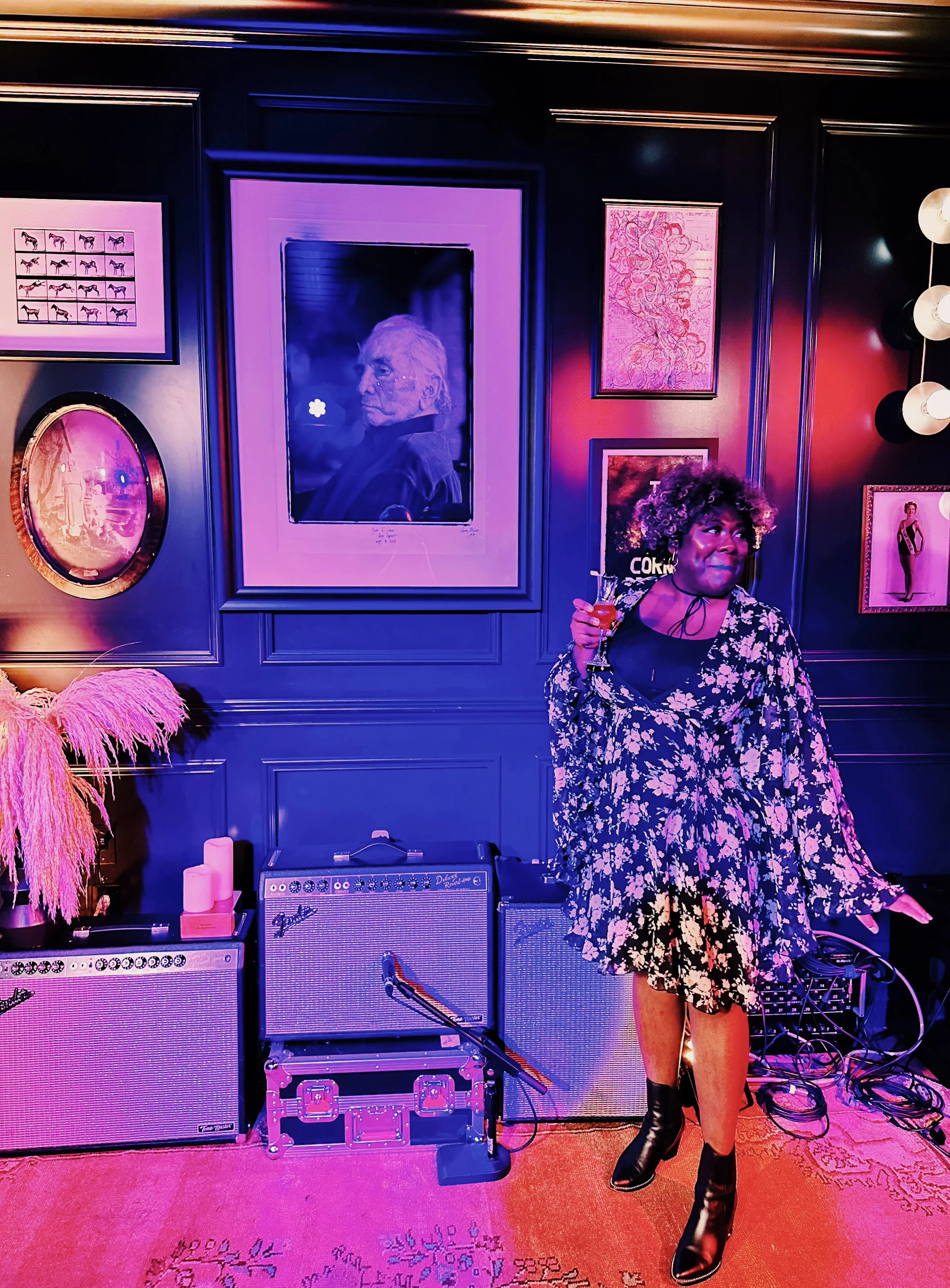 Gabrielle Nicole Pharms posing in front of Johnny Cash photo inside Virgin Hotel Nashville's The Late Great cocktail bar.