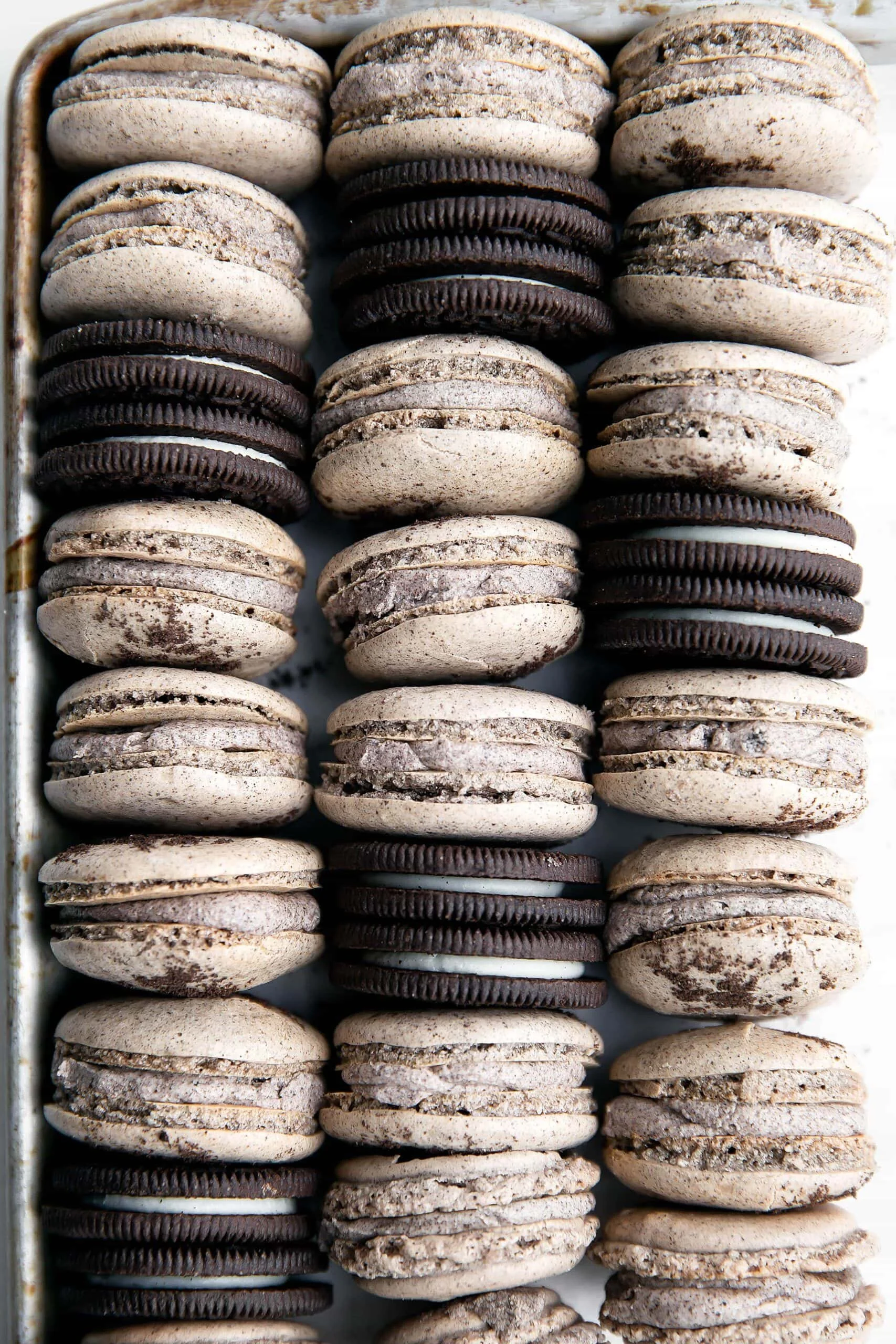A close-up view of a box filled with chocolate and cream sandwich cookies stacked in multiple rows.