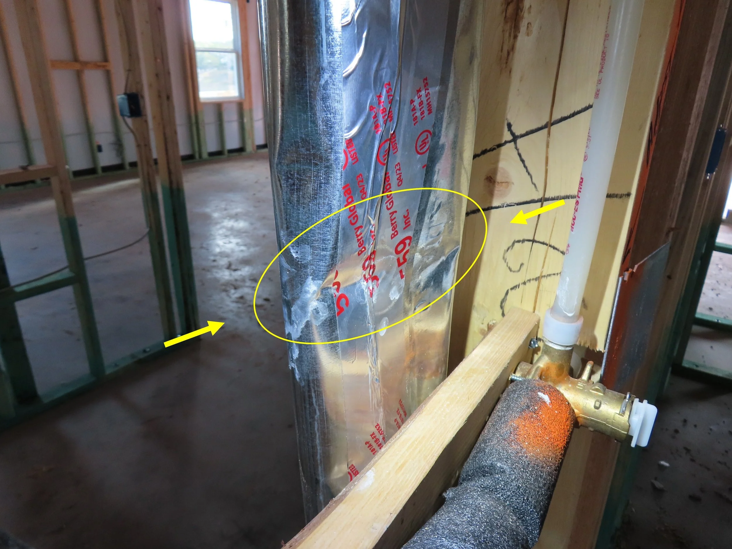 A dryer vent tube that has been crushed but still used in a home being built.